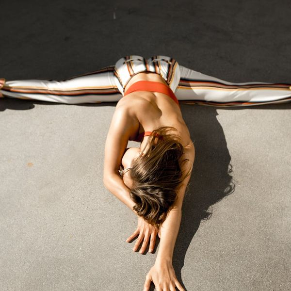 Person stretching gracefully outdoors with a focus on flexibility.